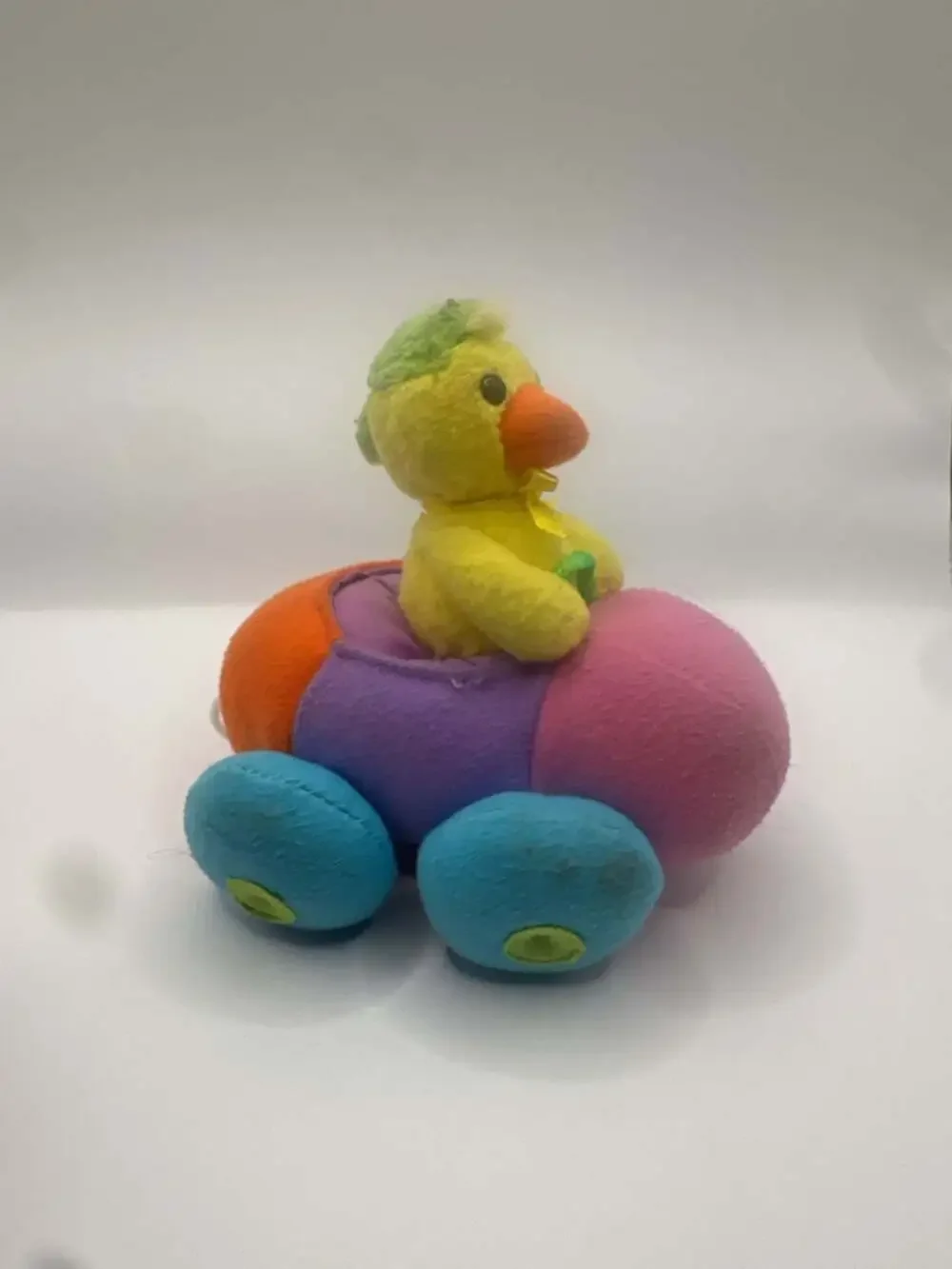 Vintage Pull-Back Toy Chick Driving a Multi-Colored Plush Bumper Car